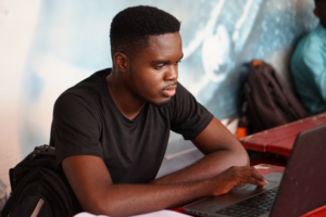Student sitting in front of a laptop.