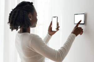 woman-pressing-smart-home-automation-panel-monitor