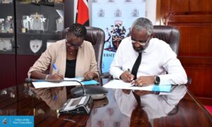Annepeace Alwala - Vice President - Global Service Delivery at Sama (Left) and Prof. Stephen Kiama, Vice-Chancellor of the University of Nairobi (Right) signing a partnership designed to advance the Generative AI (GenAI) industry in Kenya.